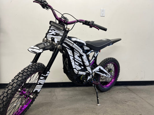 surron x ebike with snow camo wrap and purple accent color